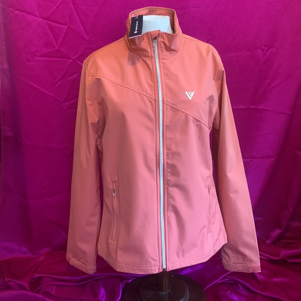 NWT levelwear size M, soft orange in colour. Wind and water resistant